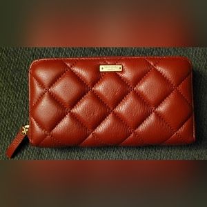 Kate Spade FEATURES 7.75"l x 1"w x 4"h quilted smooth leather 2 way spade jaquar